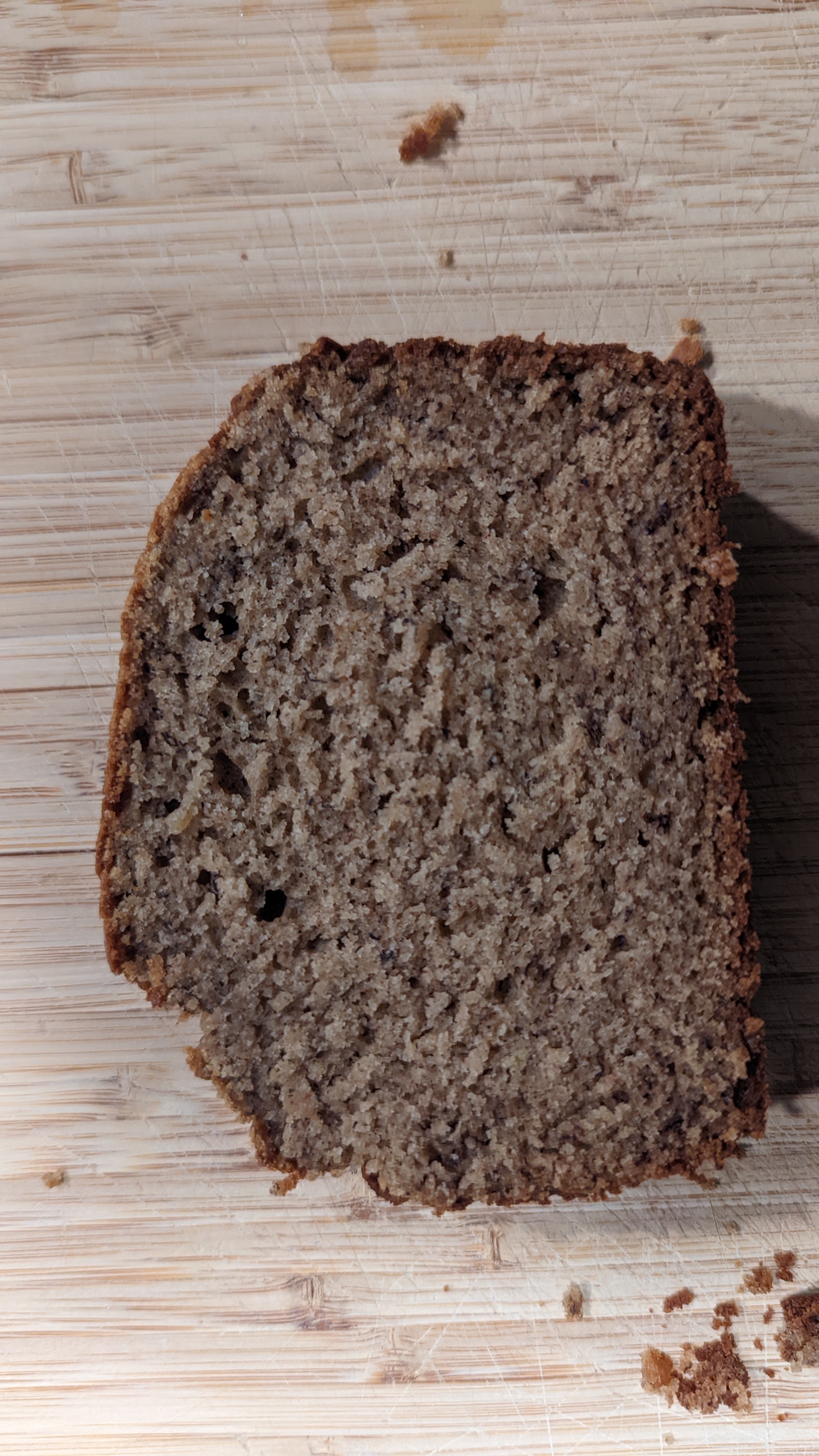 slice of banana bread on a wooden cutting board